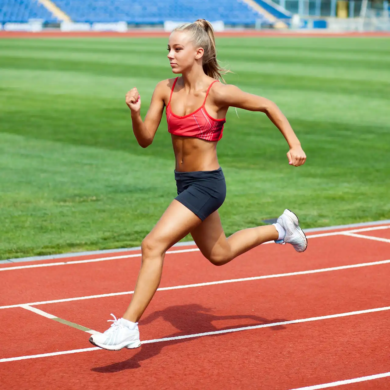 Young Female Athlete Running Track
