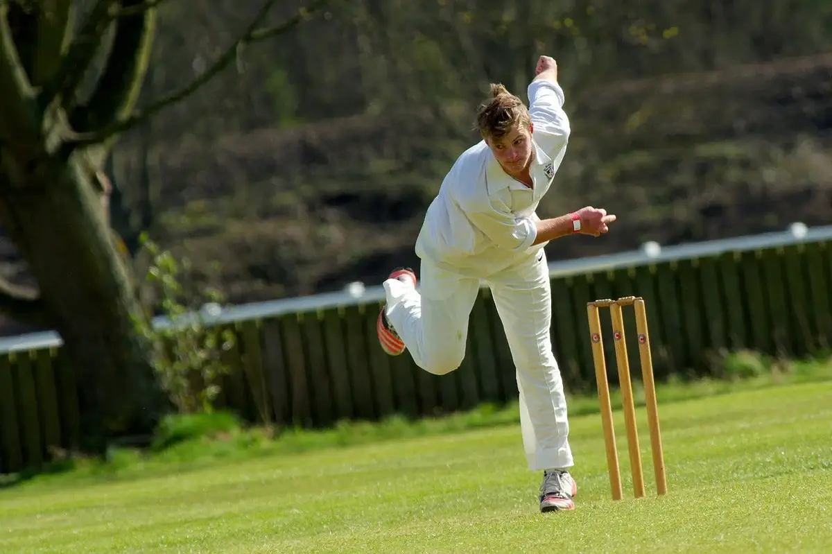 Young cricket player bowling a ball